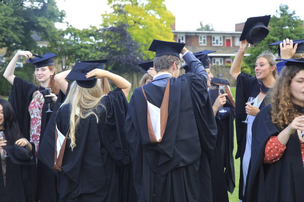 Graduates in gowns holding their mortarboards, Goldsmiths, University ...