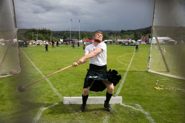 A young man takes part in the Highland Games. Credit: Kristian Buus/In Pictures via Getty Images