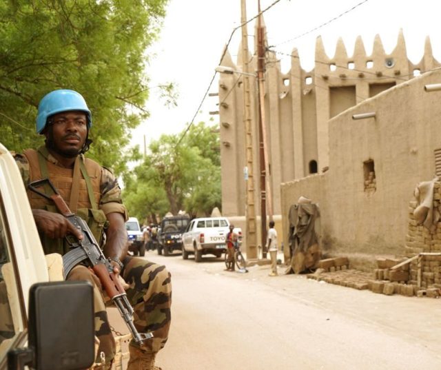 A UN peacekeeper patrols outside the mosque in Mopti, Mali, Credit : Sebastien Rieussec / Getty Images