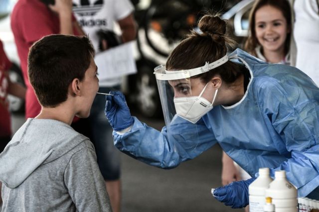 Getting tested for the old corona. Photo by SAKIS MITROLIDIS/AFP via Getty Images
