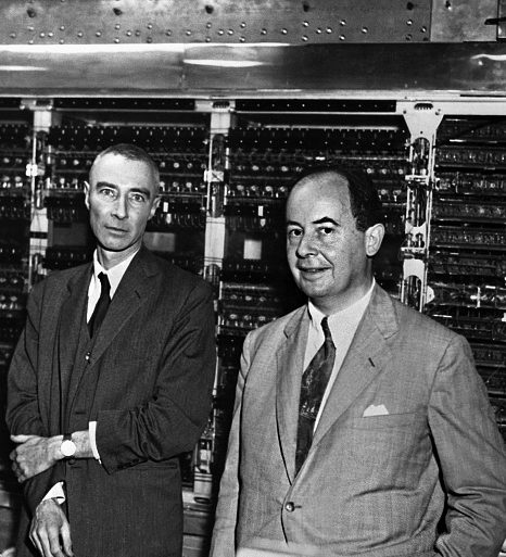 Puzzling: Dr. J. Robert Oppenheimer, left, and Dr John Von Neumann in front of a 'computer'.