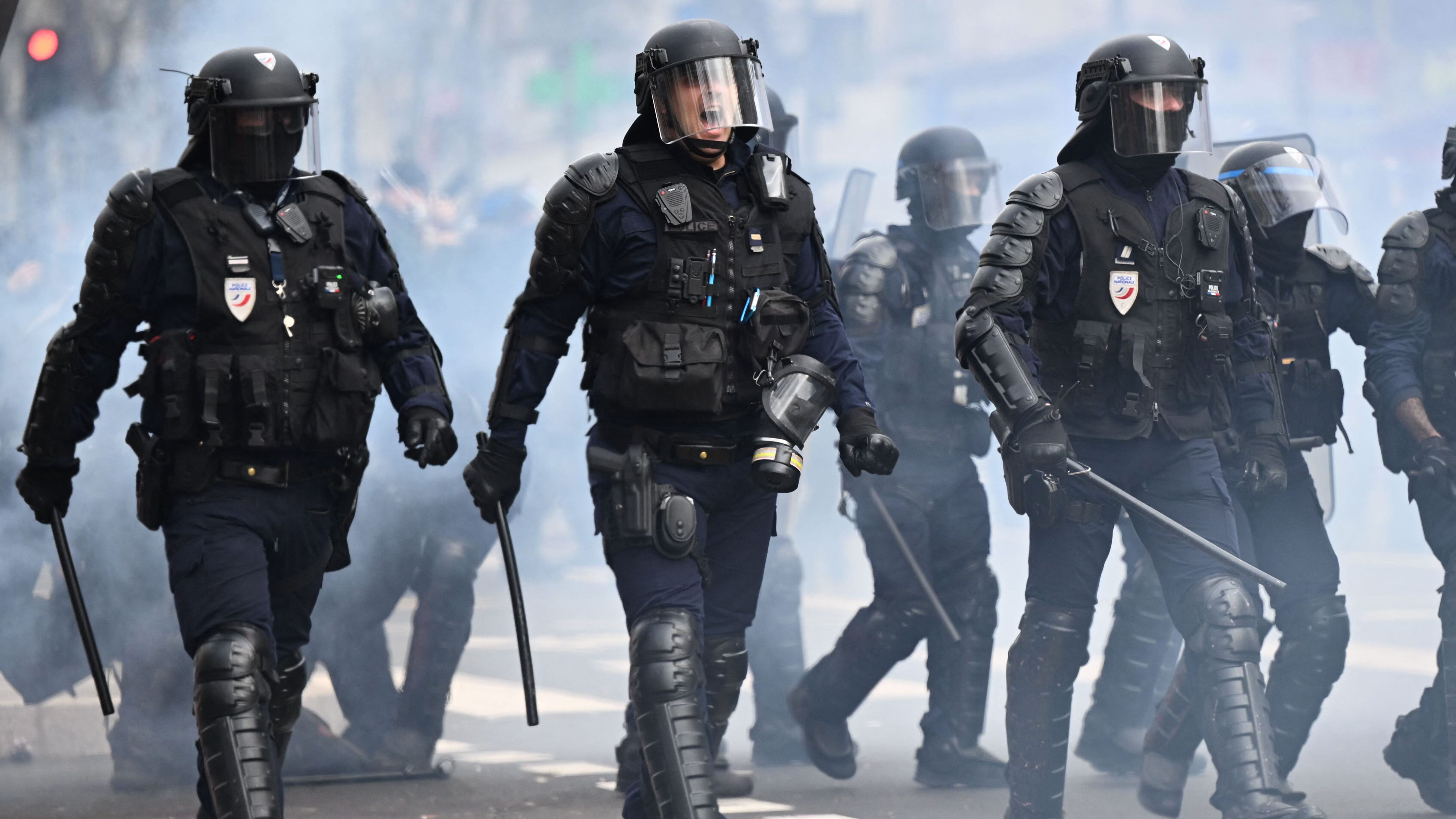 Riot police walk towards demonstrators in Paris. Credit: Getty