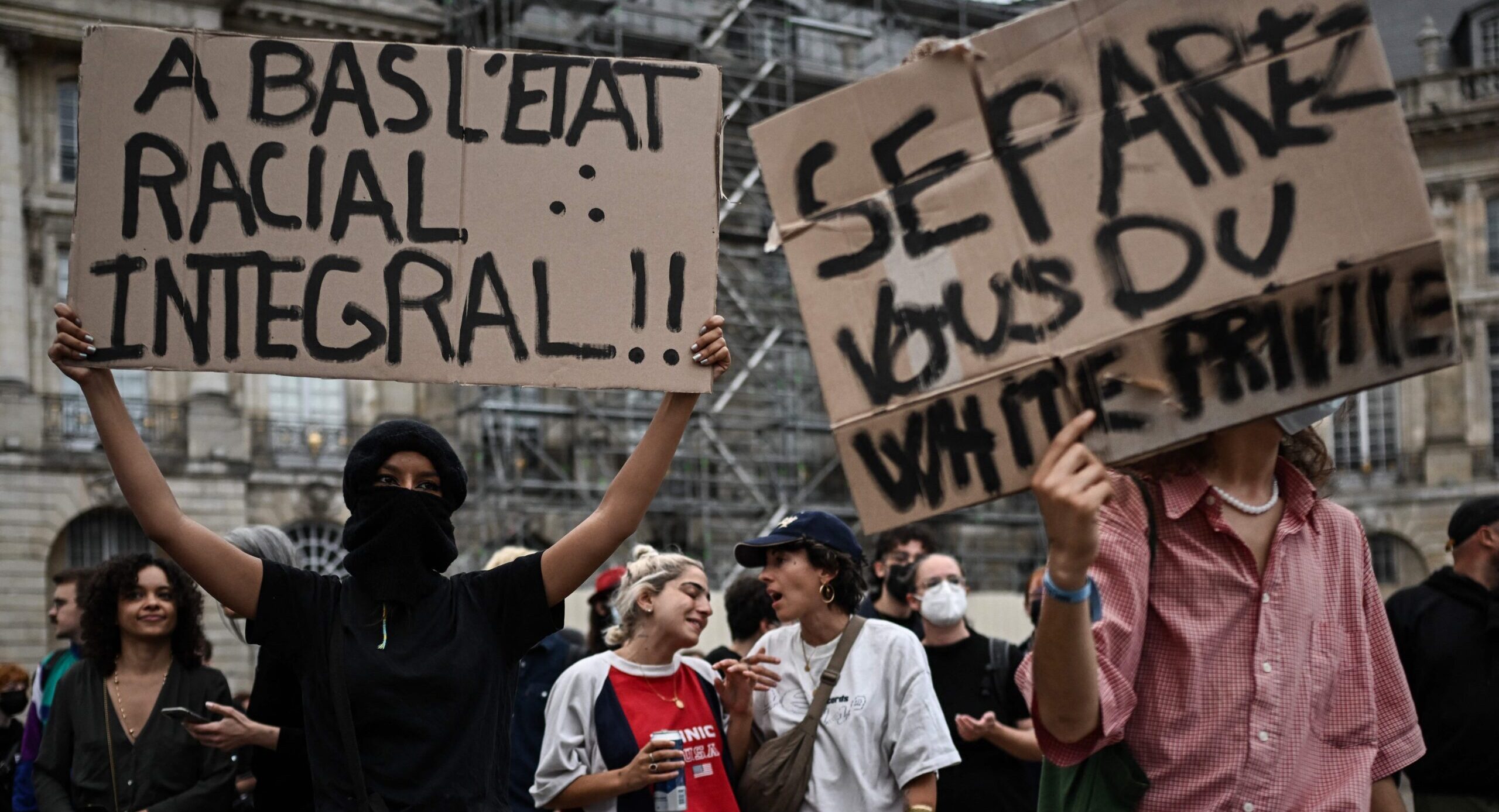 "Down with the total racial state!" and "Get rid of white privilege" signs in Bordeaux. Credit: Getty