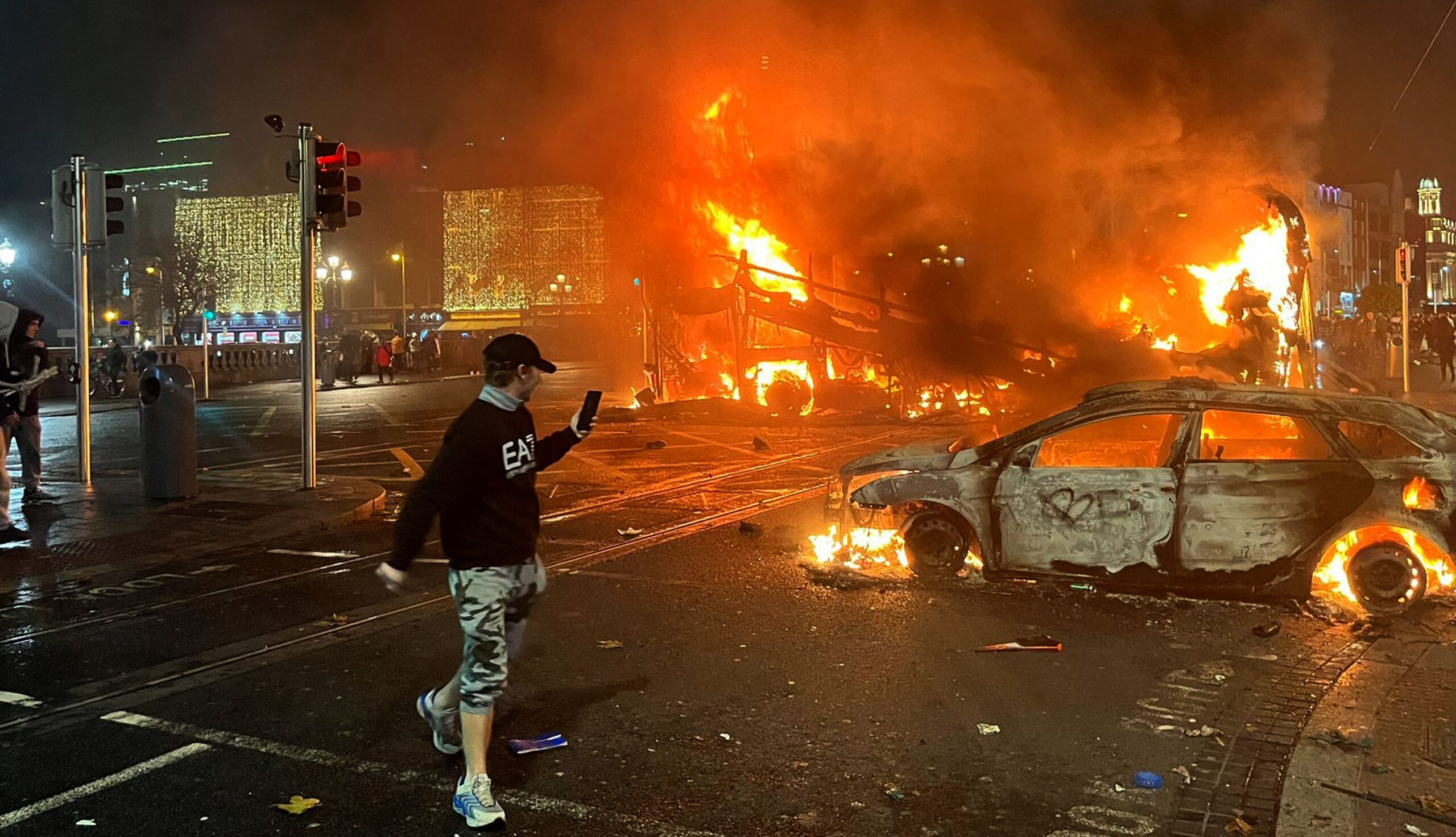 A car and bus are set on fire near O'Connell Bridge in Dublin last night. Credit: Getty