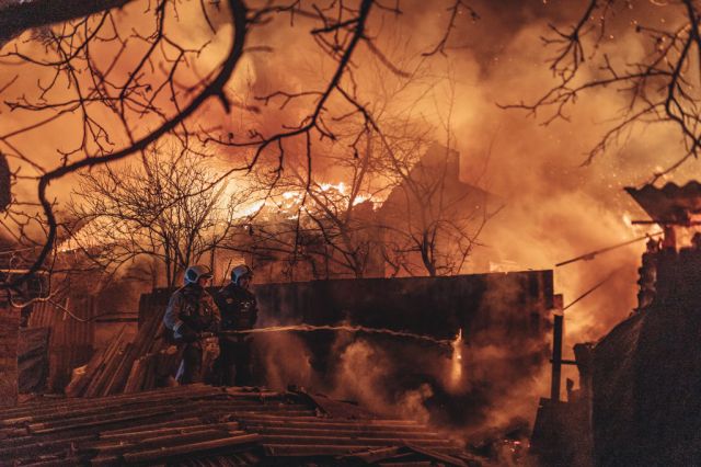 Emergency service workers extinguish a fire after shelling on the Bakhmut frontline (Diego Herrera Carcedo/Anadolu Agency via Getty Images)