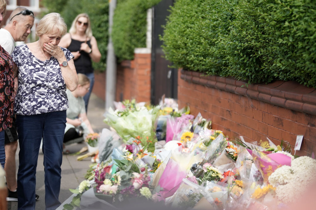 Mourners gather today at the site of the stabbings which killed three young girls. Credit: Getty