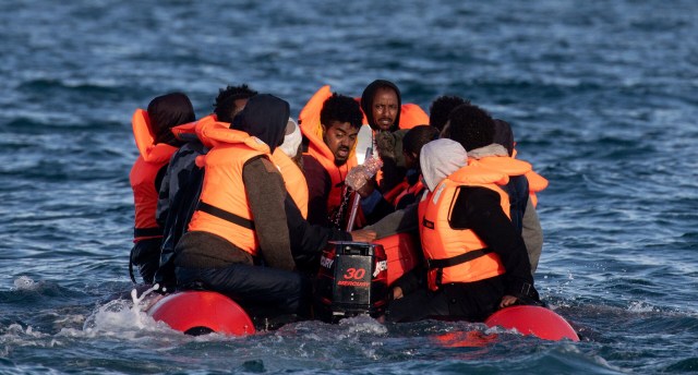 Migrants on an inflatable boat attempt to cross the English Channel. Credit: Getty