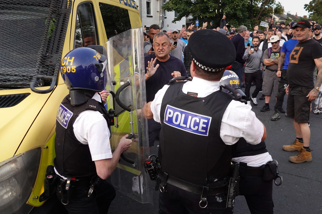 Riot police hold back protesters in Southport earlier this week. Credit: Getty