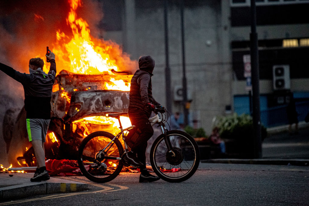 A police car is set on fire during riots in Sunderland last week. Credit: Getty