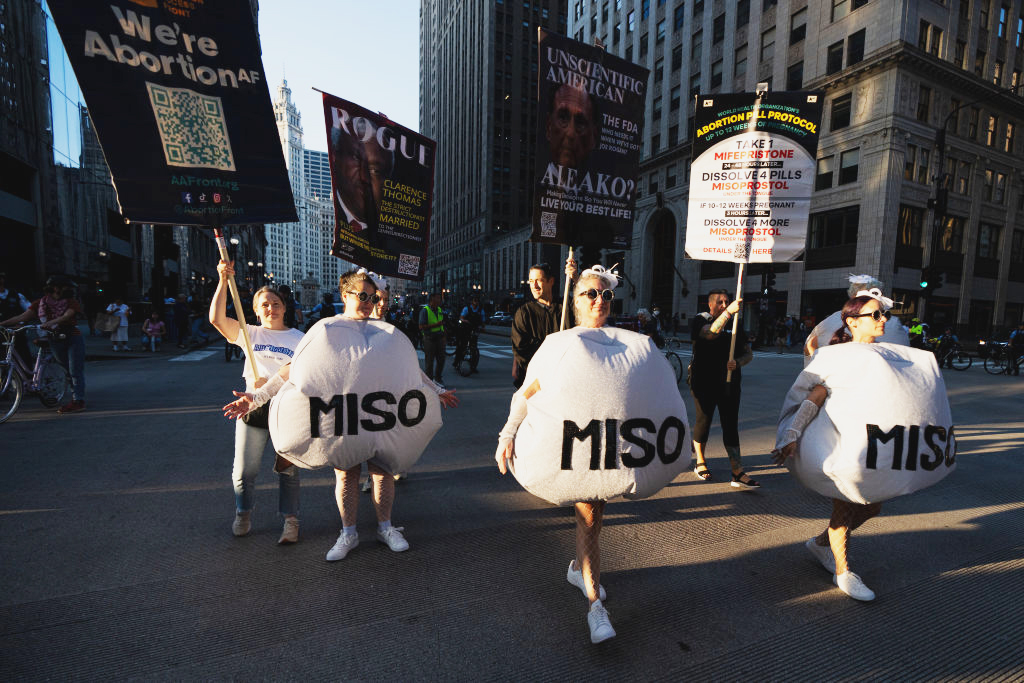 Reproductive rights demonstrators dressed as misoprostol tablets march in protest ahead of this week's Democratic National Convention. Credit: Getty 