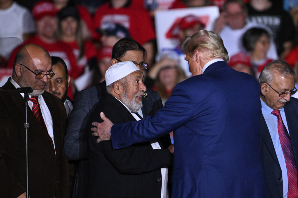 Donald Trump greets local leaders of the Muslim community who endorsed him at a rally in Michigan. Credit: Getty