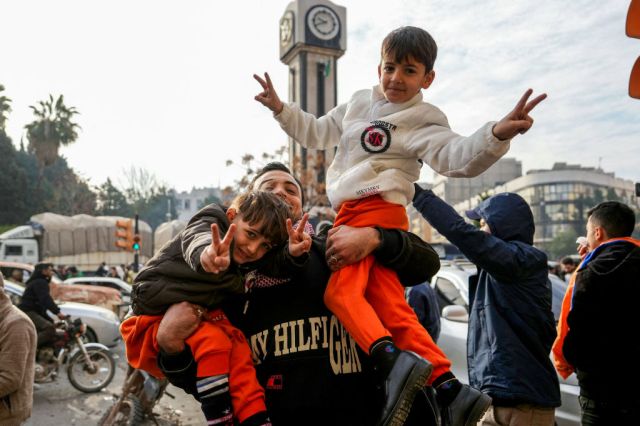 Syrians celebrate the flight of Assad. (Credit: Muhammad Haj Kadour/AFP/Getty)