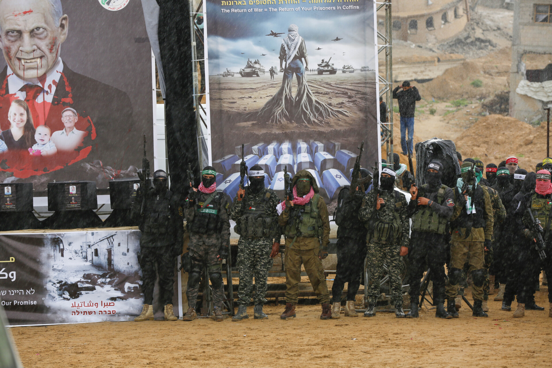 Hamas members stand next to the coffins of deceased Israeli hostages. Credit: Getty