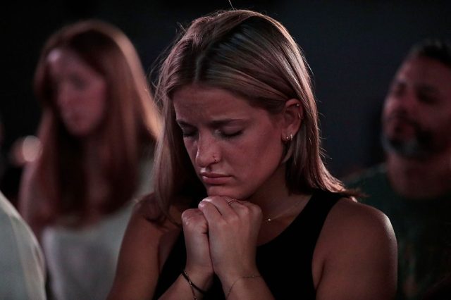A woman praying at a service held in the Liberty Tree Mall in Massachusetts. Credit: Getty