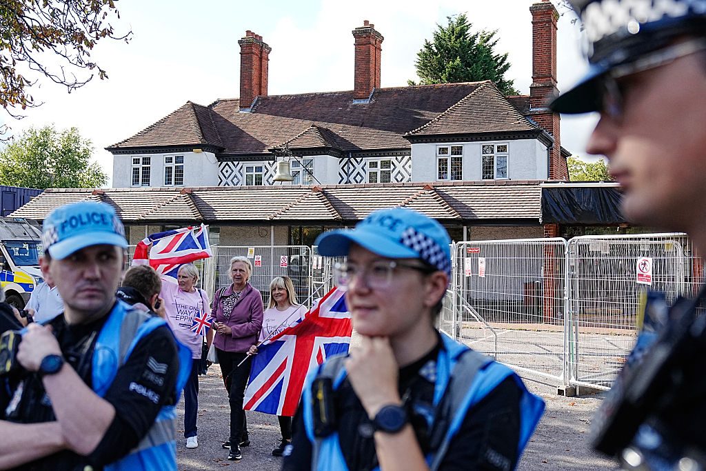 ‘Protesters dubbed “Pink Ladies” hold union flags outside The Bell Hotel in Epping back in August.’ Credit: Getty
