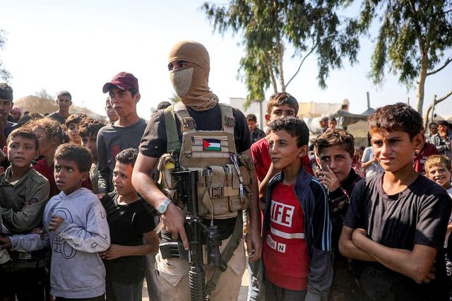 Hamas fighters alongside local children in the Gaza Strip this week. Credit: Getty