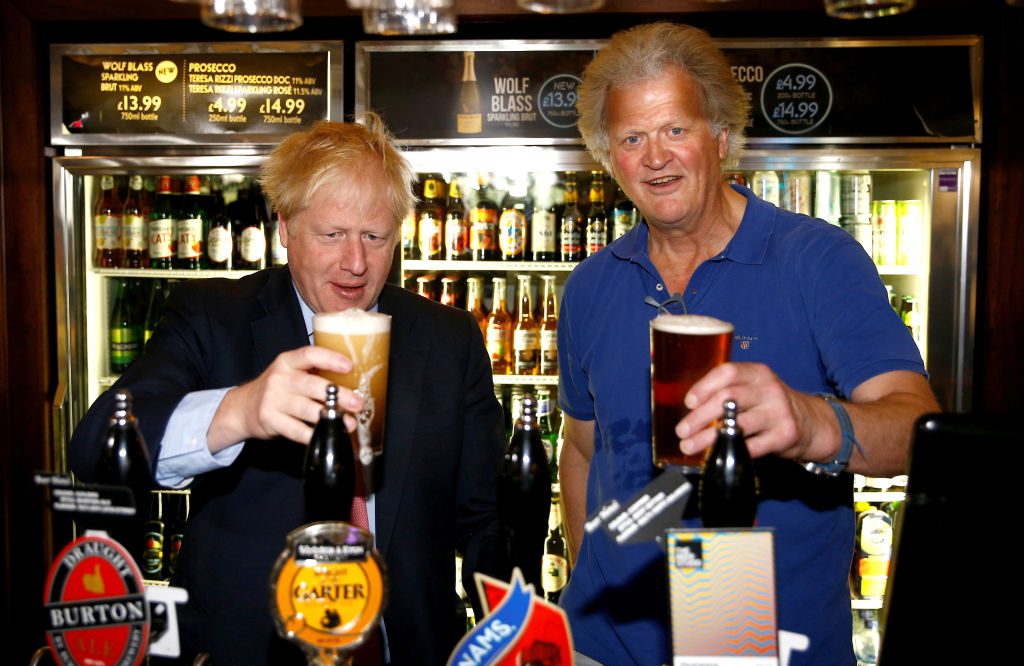 Wetherspoons founder Tim Martin poses with a regular. Credit: Getty