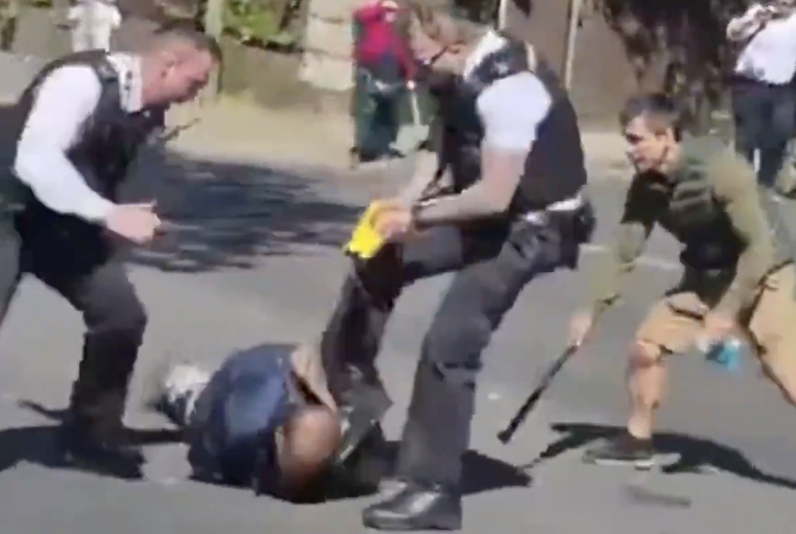 Officers subdue Essa Suleiman in Golders Green yesterday. Credit: Metropolitan Police