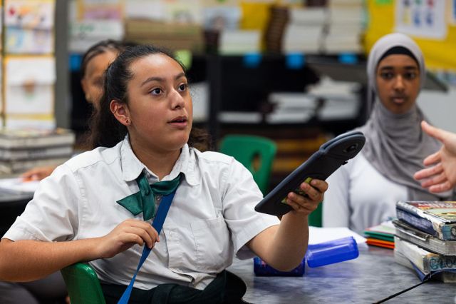Schoolgirls in California relinquish their phones. Credit: Getty