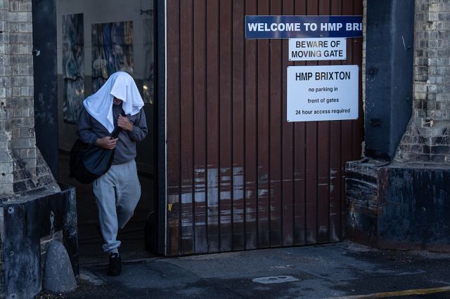 An inmate leaves HMP Brixton on early release this morning. Credit: Getty