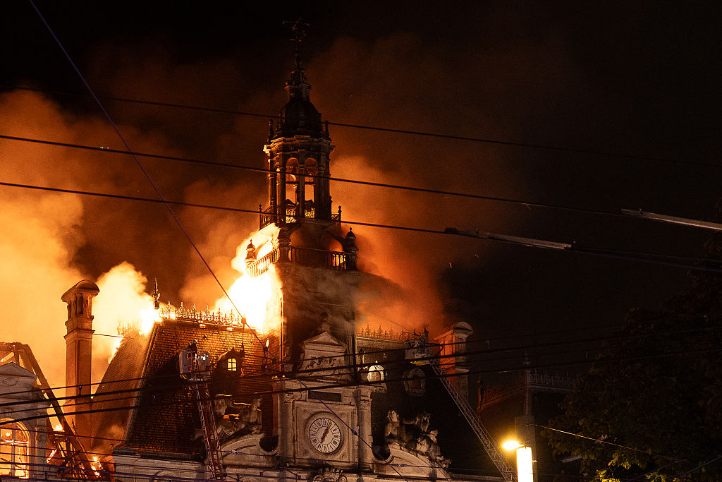 Limoges Town Hall’s clock tower folded into the flames yesterday. Credit: Getty